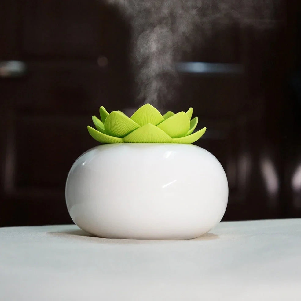 Lotus-shaped aromatherapy humidifier with ceramic base showing green and white colour option