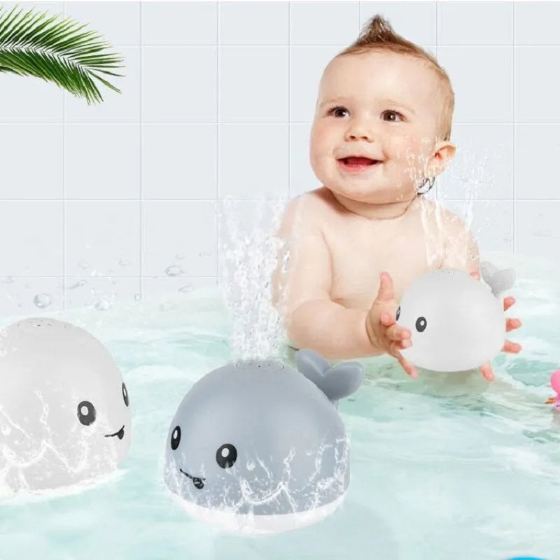 Automatic water-spraying whale bath toy with colourful lights floating in bath water.