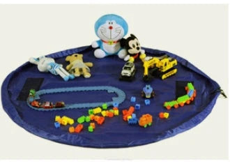 A large, waterproof travel picnic mat made of durable nylon with convenient toy storage bags for outdoor adventures.