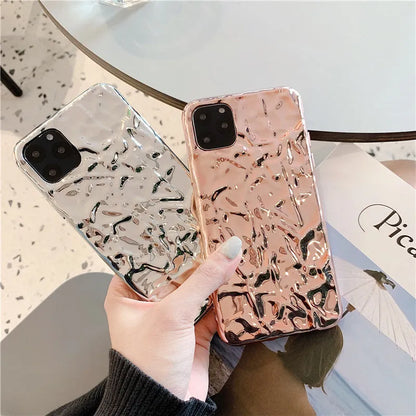 Rose gold electroplated TPU back cover case for iPhone on a table.