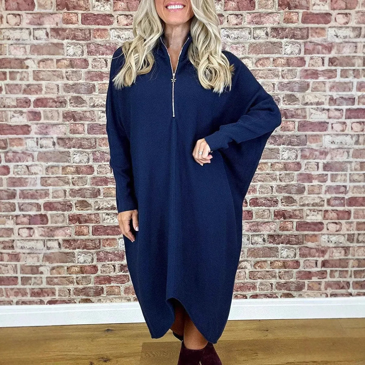 Women's solid colour loose fit knitted dress with raglan sleeves and a front zipper.