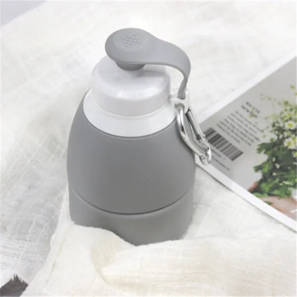 Blue silicone folding water bottle shown both extended and collapsed, next to a backpack.