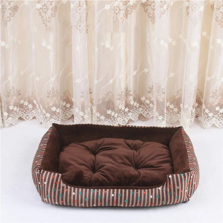 Oval cloth pet bed for dogs or cats in a striped colour pattern, showing its soft cushion shape.