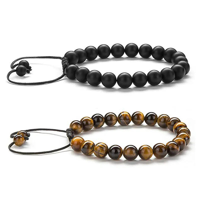 Tiger Eye and black agate geometric couple bracelets laid out as a matching set.