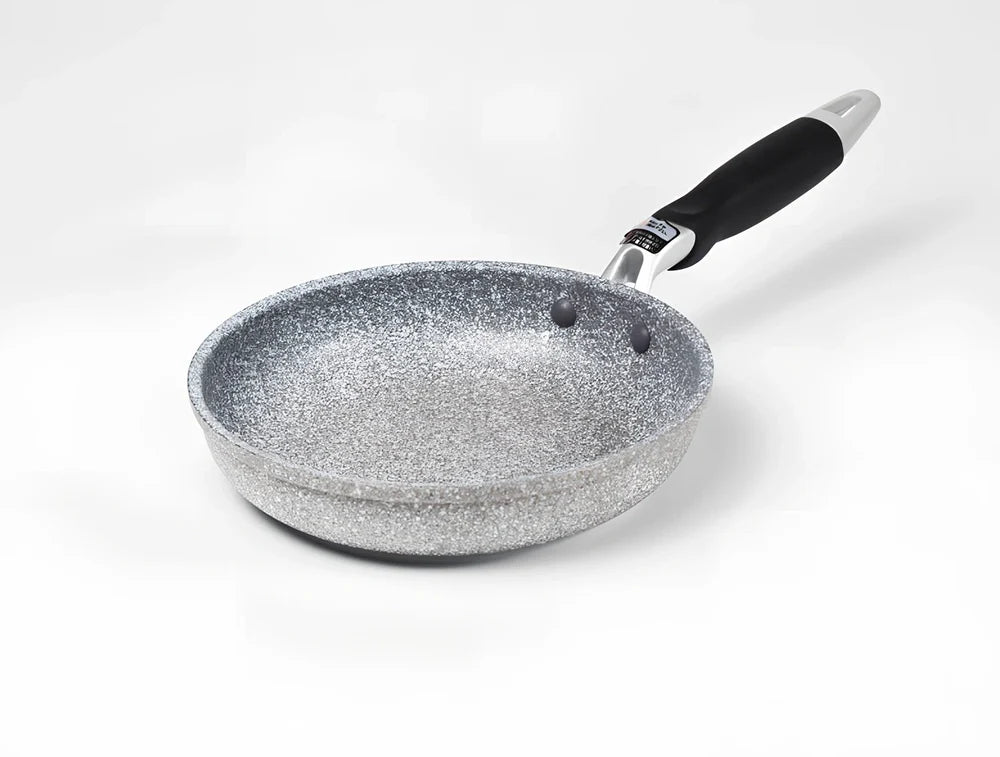 Japanese-style Maifan stone frying pan with glass lid showing non-stick surface and compound bottom
