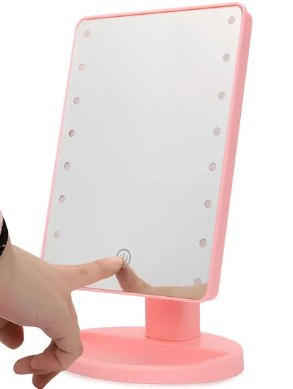 Portable tabletop cosmetic mirror with LED lights around edge, showing 360-degree rotation capability