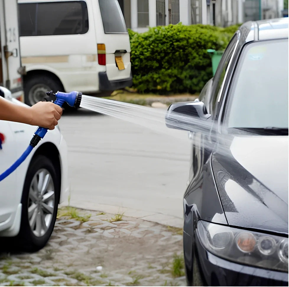 Blue telescopic water hose with high-pressure gun, expanded for use in garden watering