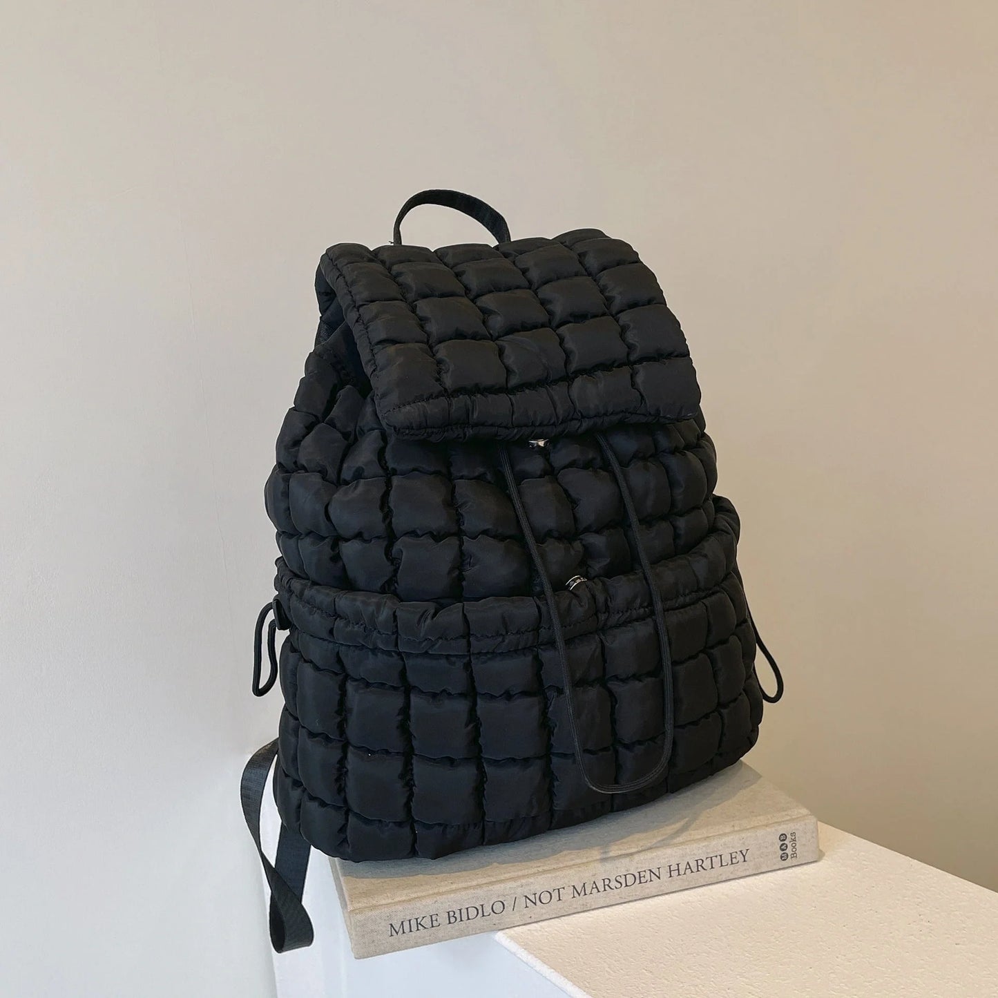 Soft, quilted puffer backpack in a variety of colors, perfect for autumn and winter wear