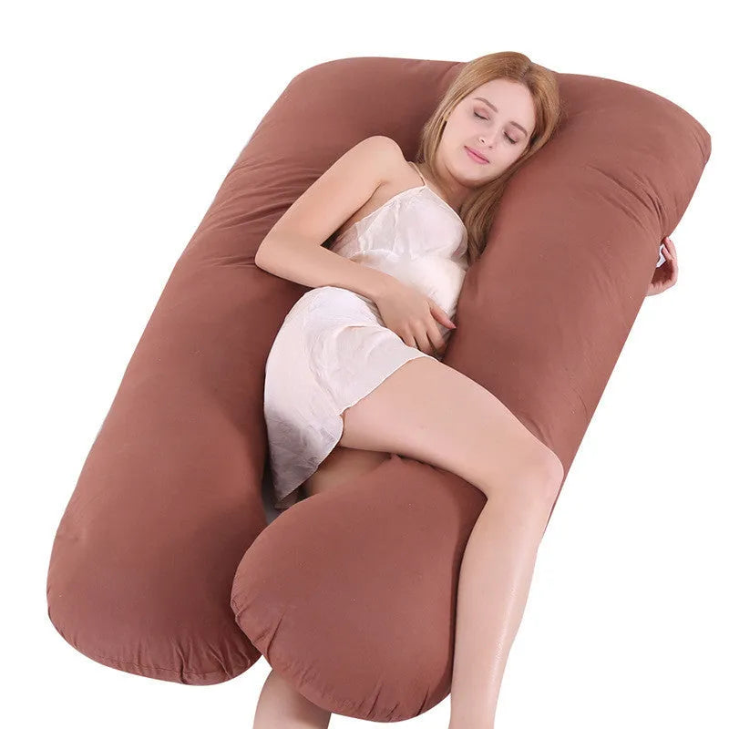 Large U-shaped pregnancy support pillow with removable cover and abdominal support belt.
