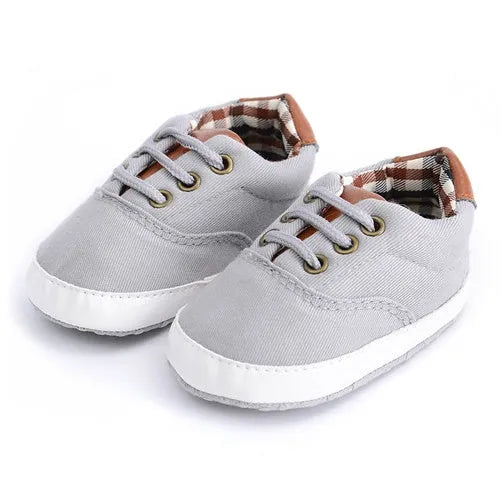 Baby canvas shoes in solid colour with soft bottom and front strap, sizes 11cm to 13cm