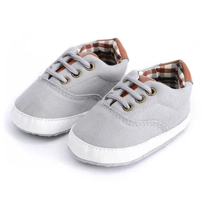 Baby canvas shoes in solid colour with soft bottom and front strap, sizes 11cm to 13cm