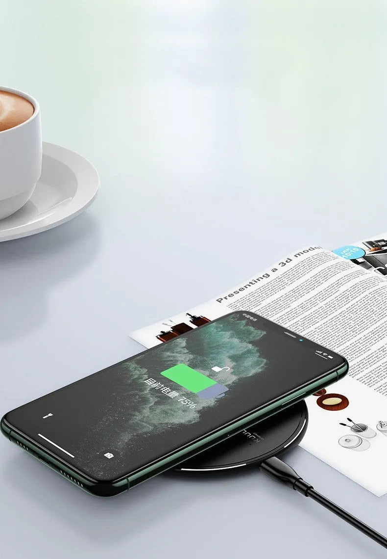 Black Kuulaa KL-CD16 wireless disc charger for mobile phones on a surface.