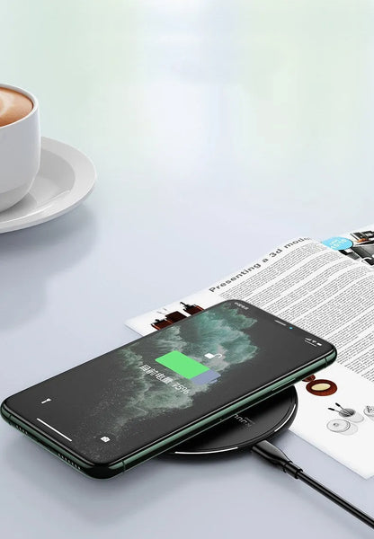 Black Kuulaa KL-CD16 wireless disc charger for mobile phones on a surface.