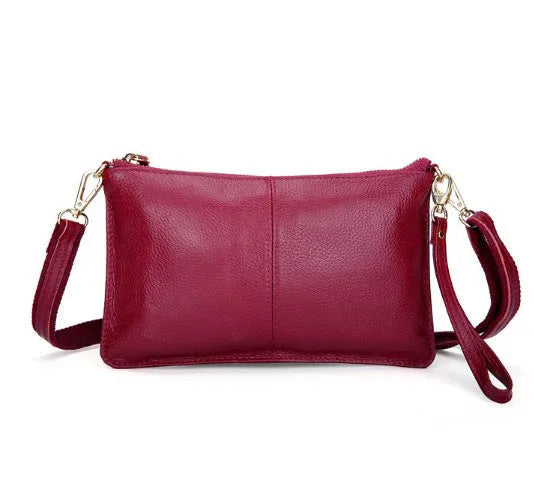 Lady's cowhide slant bag in apricot colour showing front view with strap and compact 24 cm size.
