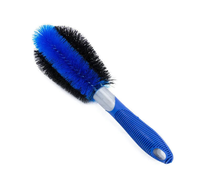 Car tire wheel brush with long handle and twisted yarn bristles for wheel hub cleaning.