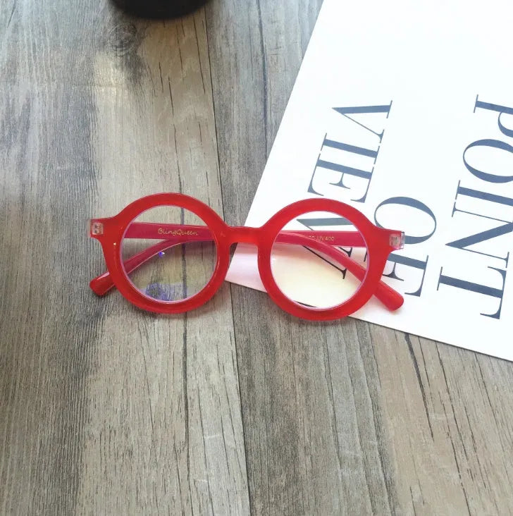 Retro round frame anti blue light glasses in various colours on a plain background