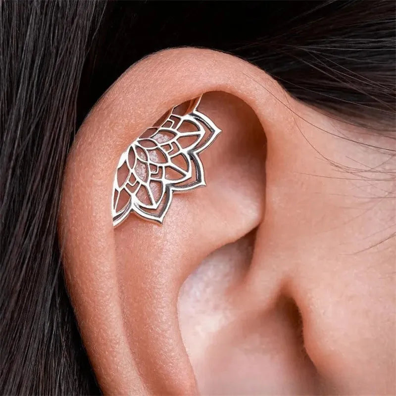 Spider web design stud earrings in gold and silver electroplated metal with geometric mesh pattern