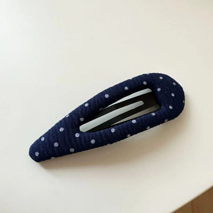 French retro dot pattern barrettes in triangle and water drop shapes with dark denim styling