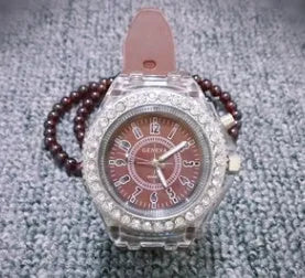 Women's LED luminous quartz watch with silicone strap and round alloy case on wrist