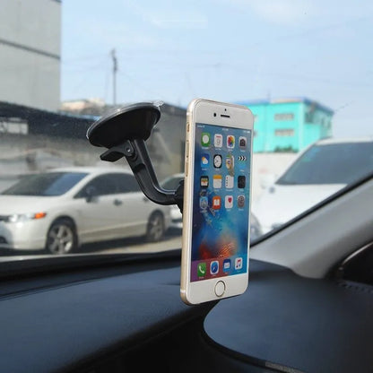 Classic black magnetic car phone holder mounted on a car dashboard, showing a smartphone attached.