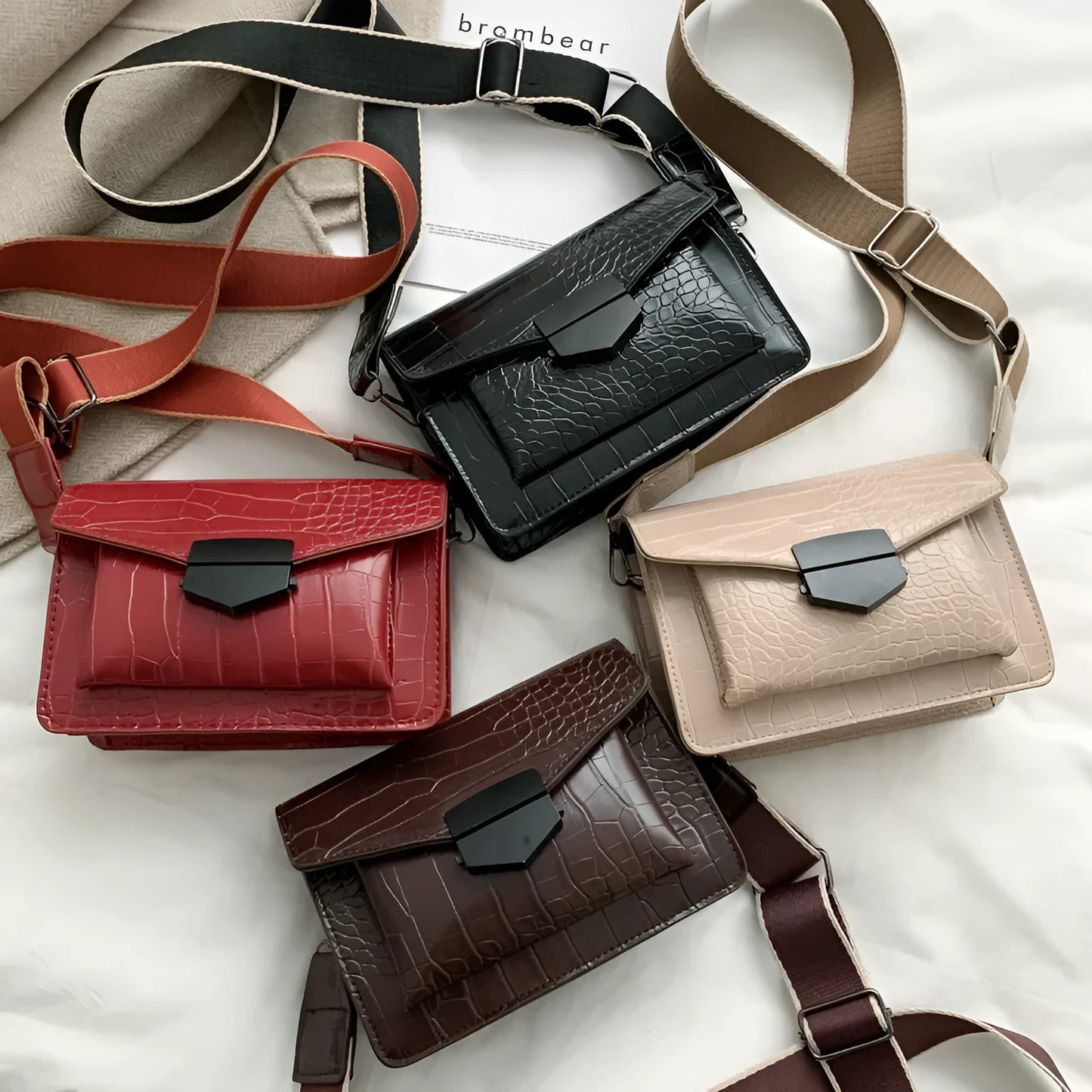 Vintage crossbody bag in black showing 20cm width, crossbody strap, and front storage compartment