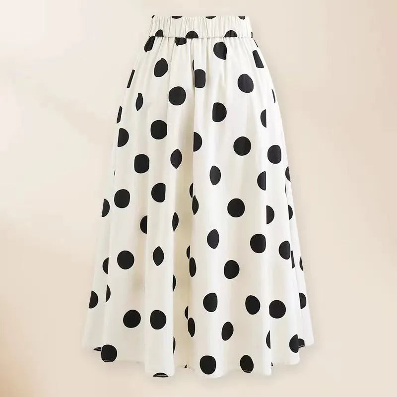 Women's black one-piece swimsuit with white skirt and bow detail for beach swimming