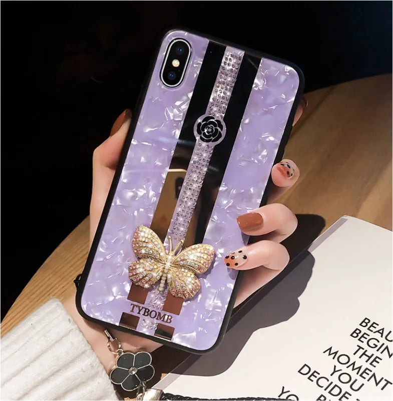 Clear acrylic iPhone case with Swarovski crystal butterfly design and central mirror in purple.
