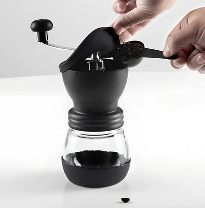 Manual coffee grinder with beech wood body and stainless steel grinding mechanism on kitchen counter