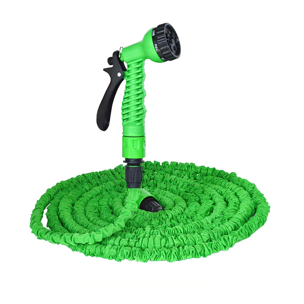 Expandable flexible water hose with spray gun showing green colour and extended length with water spraying in cone pattern