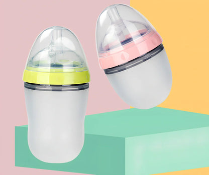 Pink and green silicone baby feeding bottles showing 4cm wide opening and soft flexible construction