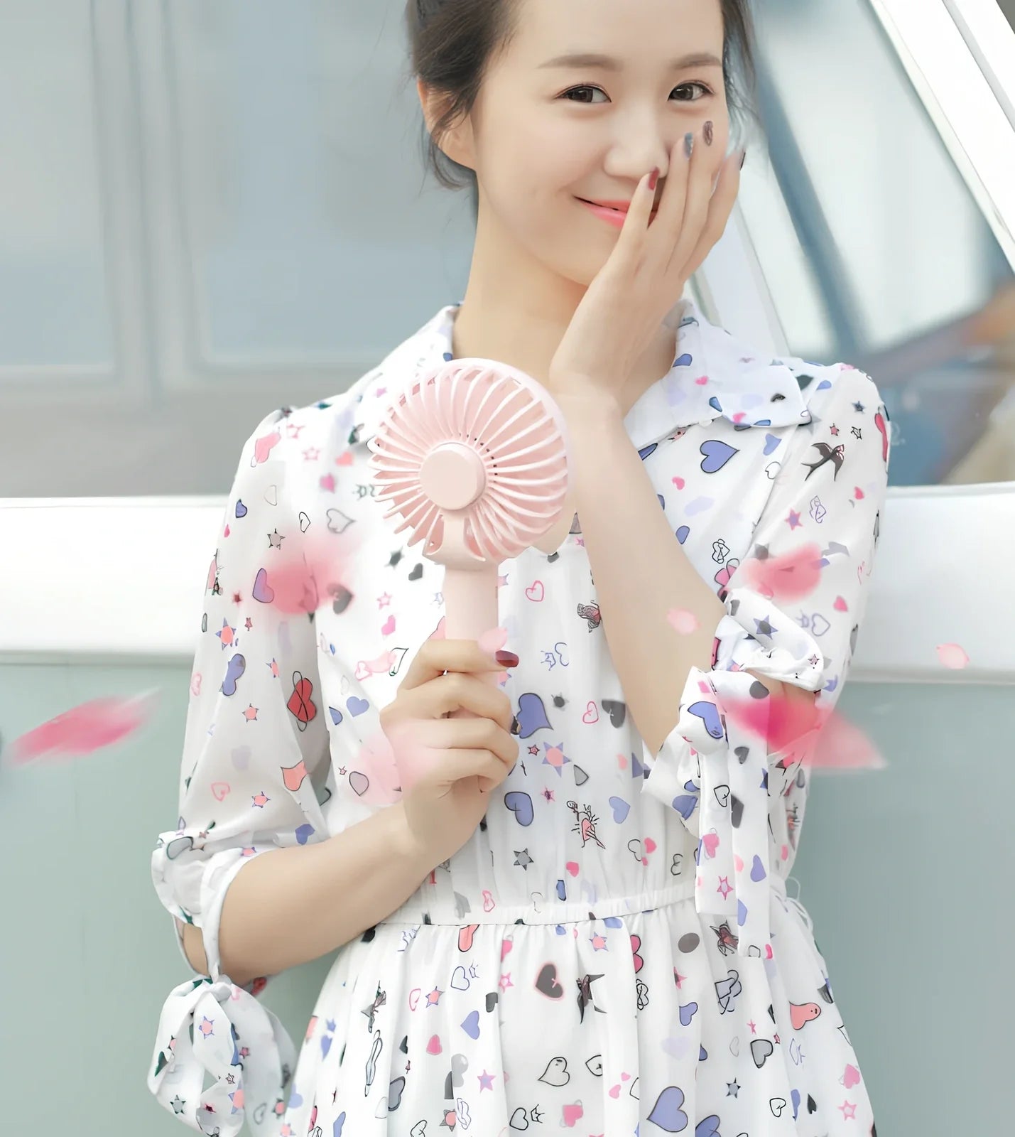 Blue shaking head handheld fan showing oscillating mechanism and USB charging port