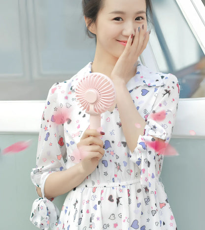 Blue shaking head handheld fan showing oscillating mechanism and USB charging port