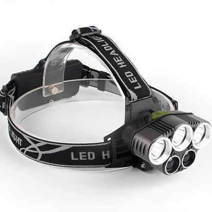 Fixed focus head torch for camping with long-range LED beam, shown with charger.