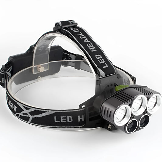 Fixed focus head torch for camping with long-range LED beam, shown with charger.