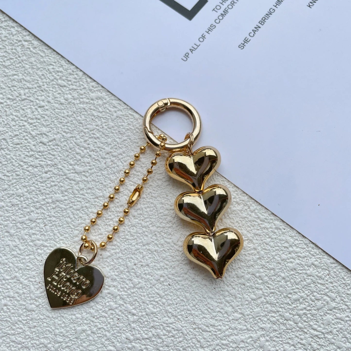 Acrylic key ring with an electroplated decorative charm in a choice of heart, bell, or water drop shapes.