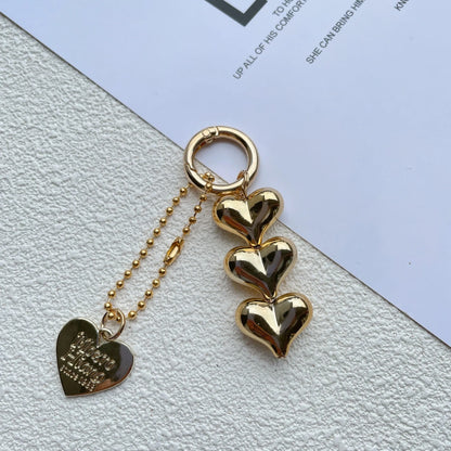 Acrylic key ring with an electroplated decorative charm in a choice of heart, bell, or water drop shapes.