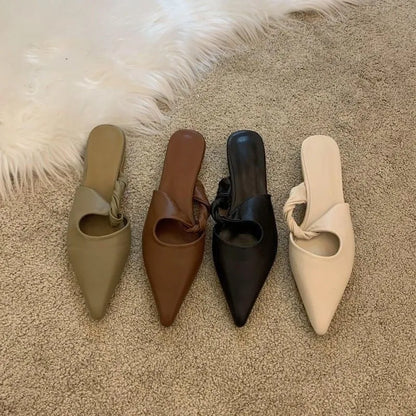Women's soft leather slippers with semi-toe box in black, khaki, cream-white, and dark brown colours on a rubber sole.