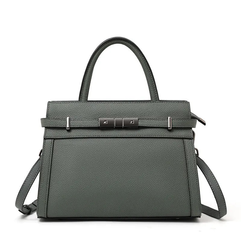 Women's square genuine leather crossbody handbag in clamshell style with internal compartments.
