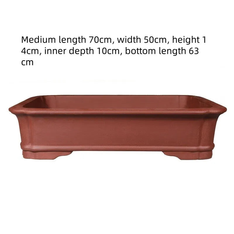 Handmade rectangular purple clay bonsai pot showing natural clay texture and rectangular shape with drainage