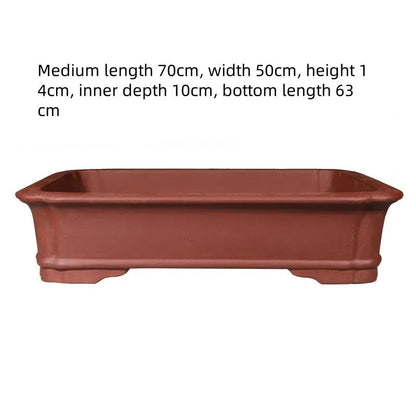 Handmade rectangular purple clay bonsai pot showing natural clay texture and rectangular shape with drainage