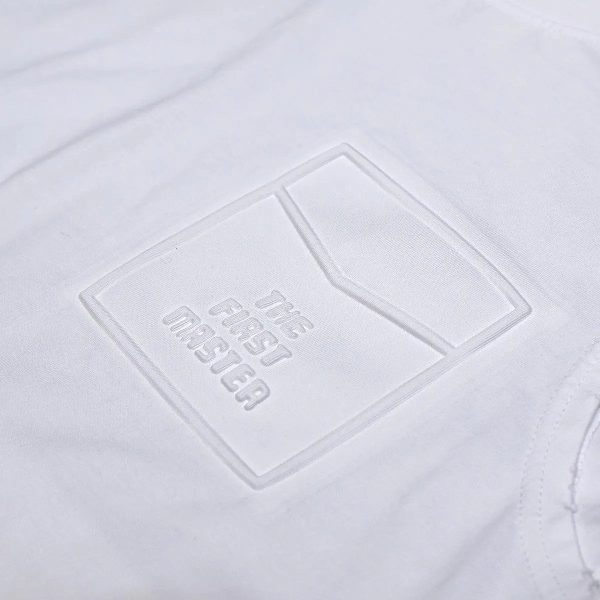 Men's solid colour loose fit cotton sleeveless t-shirt on a hanger, shown in white and black.