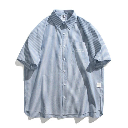 Blue and white striped loose-fitting short-sleeved overalls shirt on a hanger.