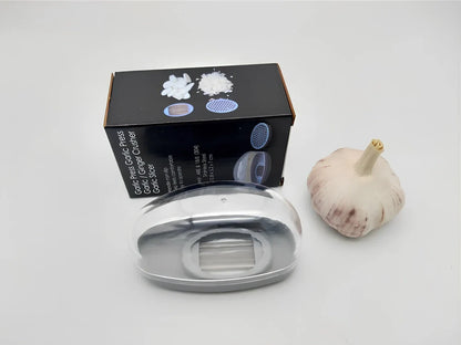 White plastic garlic cutter with stainless steel blades measuring 11cm long