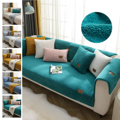 Beige lamb wool plush sofa cover with anti-slip backing on a grey fabric sofa.