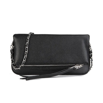 Soft black PU leather women's clutch bag with a gold chain strap, shown held and worn cross-body.