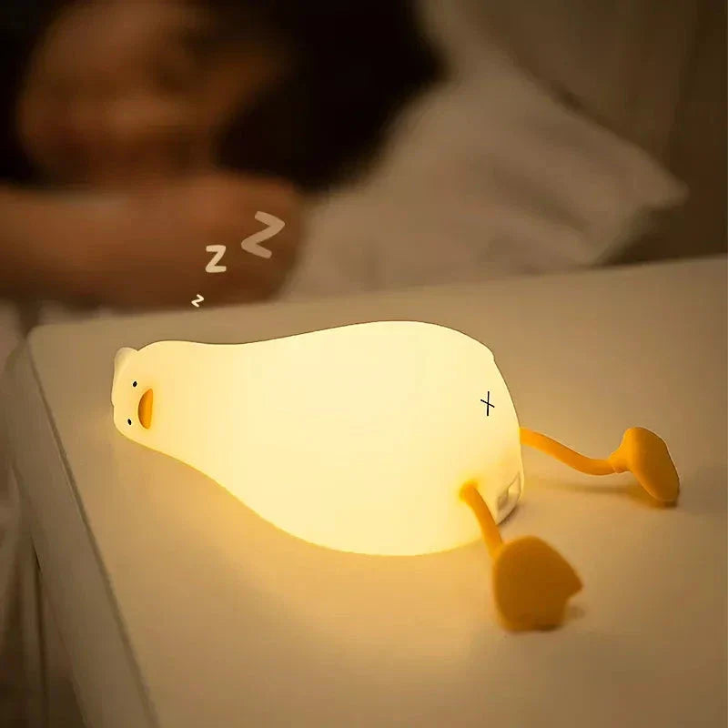 A white, duck-shaped LED night light with a soft, warm glow, providing a cozy and charming addition to any room