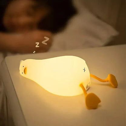 A white, duck-shaped LED night light with a soft, warm glow, providing a cozy and charming addition to any room