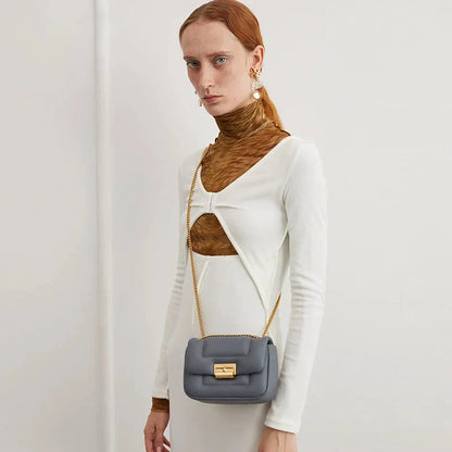 Premium grey split leather crossbody bag with adjustable metal chain strap, showcasing a compact and stylish design