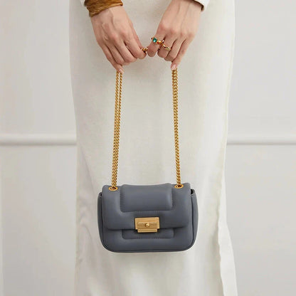 Premium grey split leather crossbody bag with adjustable metal chain strap, showcasing a compact and stylish design