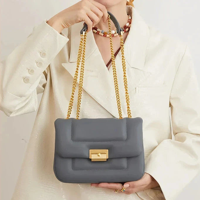 Premium grey split leather crossbody bag with adjustable metal chain strap, showcasing a compact and stylish design